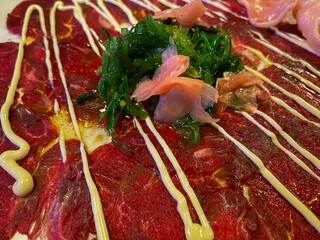 Carpaccio in asia style with mayonnaise and vegetable. Appetizer, starter food before lunch or...