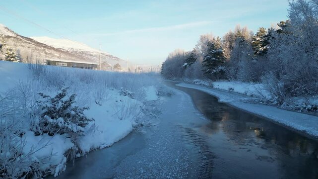 Flying over slow river during a very cold winter day at Oppdal, Norway.