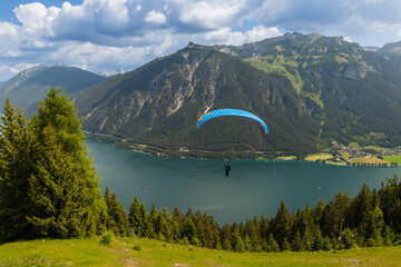 paraglider flyying in the alps at Achensee in austria 