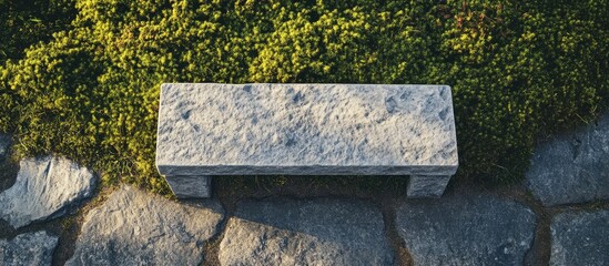 Stone bench on grass and stone pathway with natural elements and textures Copy Space