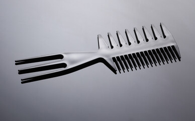 Plastic comb on black background close up