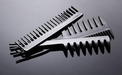Set of plastic combs on black background close-up
