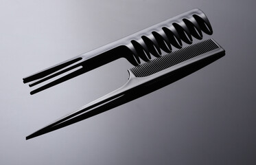 Set of plastic combs on black background close-up