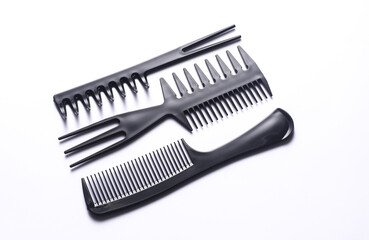 Set of black plastic combs on white background