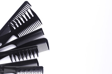 Set of black plastic combs on white background