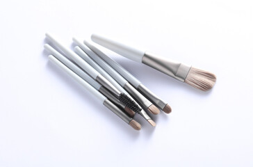 Set of makeup brushes on white background