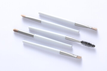 Set of makeup brushes on white background