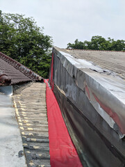 Damaged Roof Valley Grey Metal Red Underlayment and Tile Repair