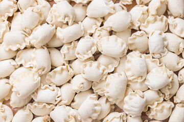 Freshly prepared Chinese meat dumplings on tray