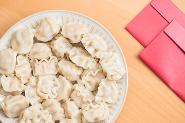 Traditional Chinese dumplings with red packet decoration