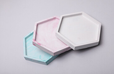Plaster hexagon trays on a gray background