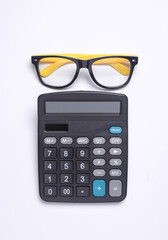 CAlculator with eyeglasses on white background