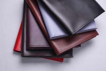 Leather organizers for important papers and documents on a white background