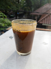 Dark Amber Beverage in Glass A Sunlit Outdoor Moment