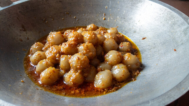 Spicy Ci Siat Warm Savory Spheres in a Rustic Wok