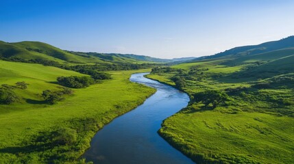 Serene River Flowing Through Green Hills Under Clear Blue Sky, Perfect for Nature Blogs, Travel Promotions, Scenic Wallpapers, Eco-Tourism Ads, and Environmental Posters