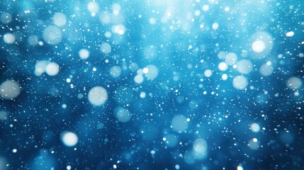 Obraz premium Blue bokeh snow falling winter background