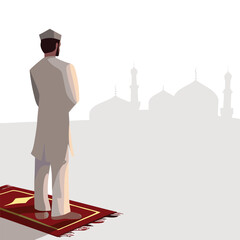Fototapeta premium Muslim Man Praying on Prayer Rug Facing Mosque