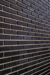 Black brick wall. Concept: Building, architecture, pattern, black brick.
