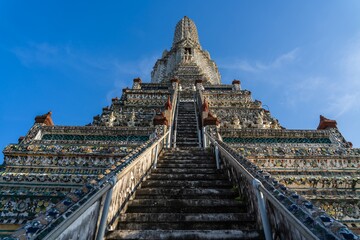 Stunning view of Wat Arun temple in Thailand showcasing intricate architecture and tall spires...