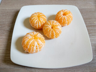 Peeled Mandarin Oranges on White Plate A Simple Fresh Still Life