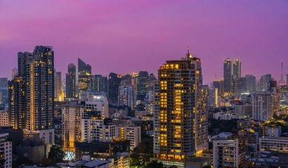 Obraz premium City skyline of Bangkok illuminated at twilight with vibrant colors and towering skyscrapers