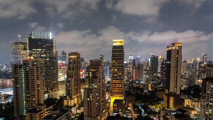 City skyline illuminated at night showcasing modern buildings and vibrant urban life in a bustling metropolitan area