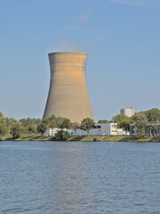 Fototapeta premium Cooling tower surrounded by trees in the harbor of Ghent, Flanders, Belgium 