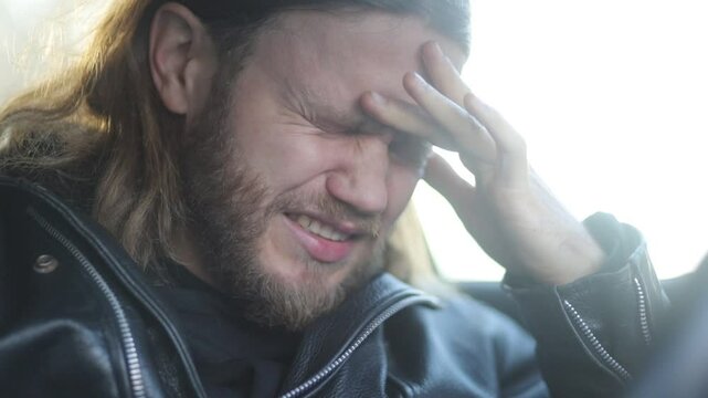 male driver worries and regrets disappointed while driving a car