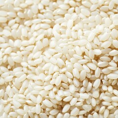 Close-up of uncooked white rice grains. Highlighting the texture and purity of the rice. Ideal for packaging designs and food advertisements.