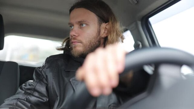 an emotional man driving a car