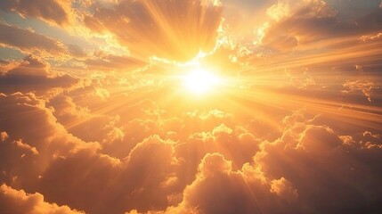 A photograph of the sun shining through clouds, casting golden rays on the earth from above in a sky view.