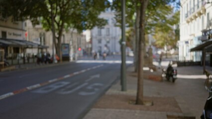 Blurred street scene in marseilles, france with defocused background capturing outdoor city life amidst bokeh effects and pedestrian movement.
