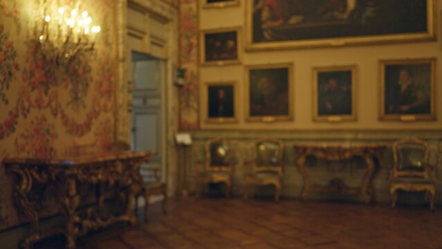 Naklejki Elegant museum room in galleria doria pamphilj with blurred vintage furniture and classic paintings, showcasing an opulent art setting filled with historical grandeur.