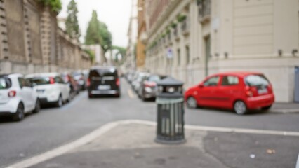 Defocused urban street view with blurred cars and buildings in rome, italy capturing a serene old town atmosphere outdoors.