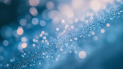 Obraz premium Subtle water droplet scattering light across a soft blue backdrop