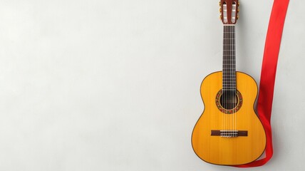 A wooden guitar with a vibrant yellow body is leaning against a wall, adorned with a red ribbon, creating a warm and inviting atmosphere.