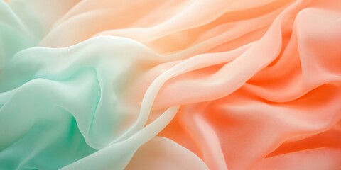 Obraz premium Textiles in soft hues of orange and turquoise drape gracefully, showcasing delicate folds and a serene ambiance, perfect for creating a tranquil atmosphere