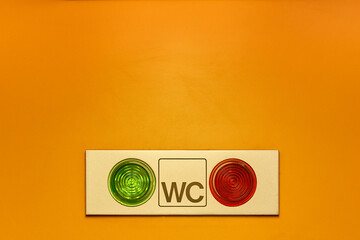 Toilet Availability Indicator Panel with Green and Red Lights on Yellow Background – WC Occupied or Free Signal