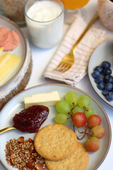 Assortment of various breakfast foods and drinks on the white table. Selective focus.