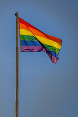 LGBTQ flag Low angle view of rainbow against a blue sky on a sunny day