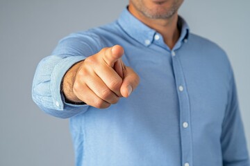 Man gesturing with pointing finger against a rustic brick wall in a casual setting