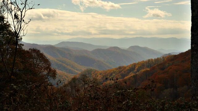 Rolling Appalachian Mountain peaks covered in autumn colors framed by trees.