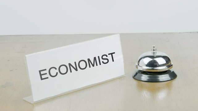 Economist Office or Room with Hand Ringing The Bell on Desk or Table Multiple Times