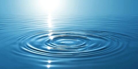 Dynamic water ripples reflecting sunlight on a tranquil blue surface under a bright horizon