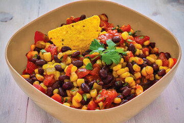 corn and black bean salsa served in a tan bowl