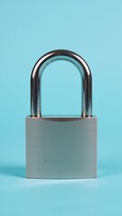 Fototapeta premium Shiny closed padlock symbolizes security against a light-blue backdrop