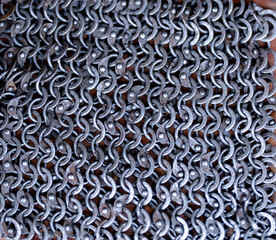 A close up of a chain link fence with many small metal links