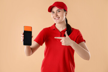 Happy courier with payment terminal on beige background