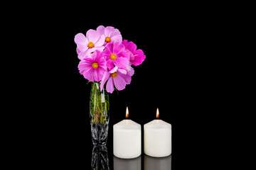 Photo of candles and flowers on black background